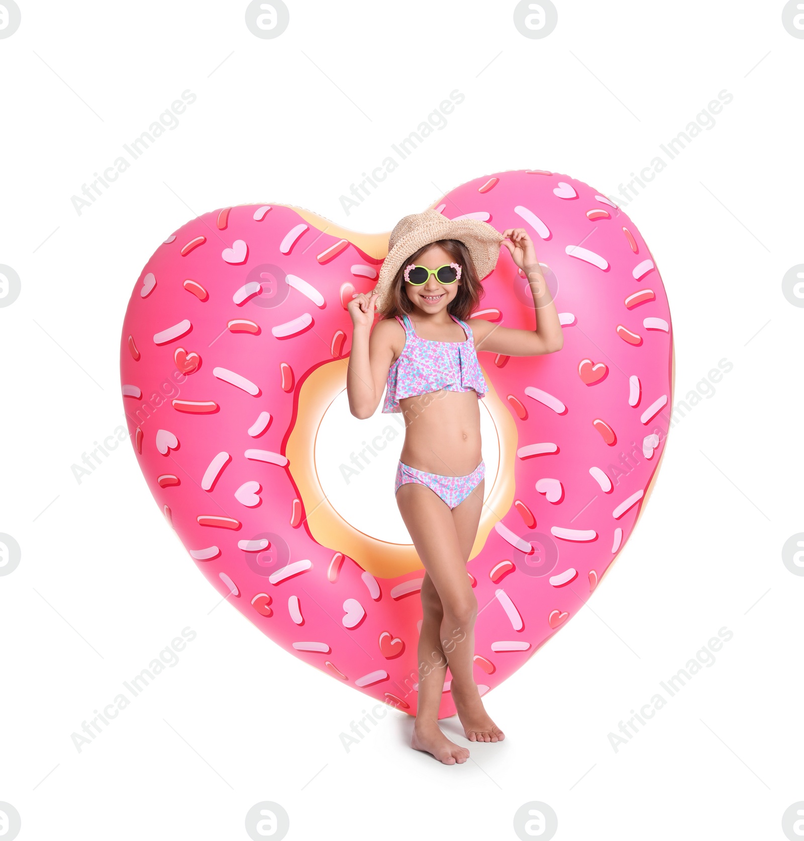 Photo of Cute little girl with inflatable heart on white background