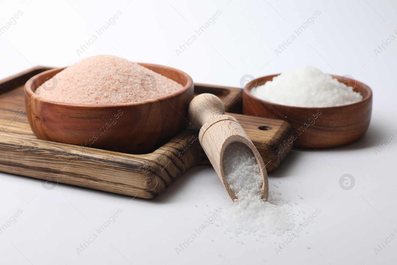 Photo of Different types of natural salt on white background