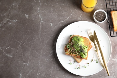 Tasty toasts with avocado, sprouts and chia seeds served on table, top view. Space for text