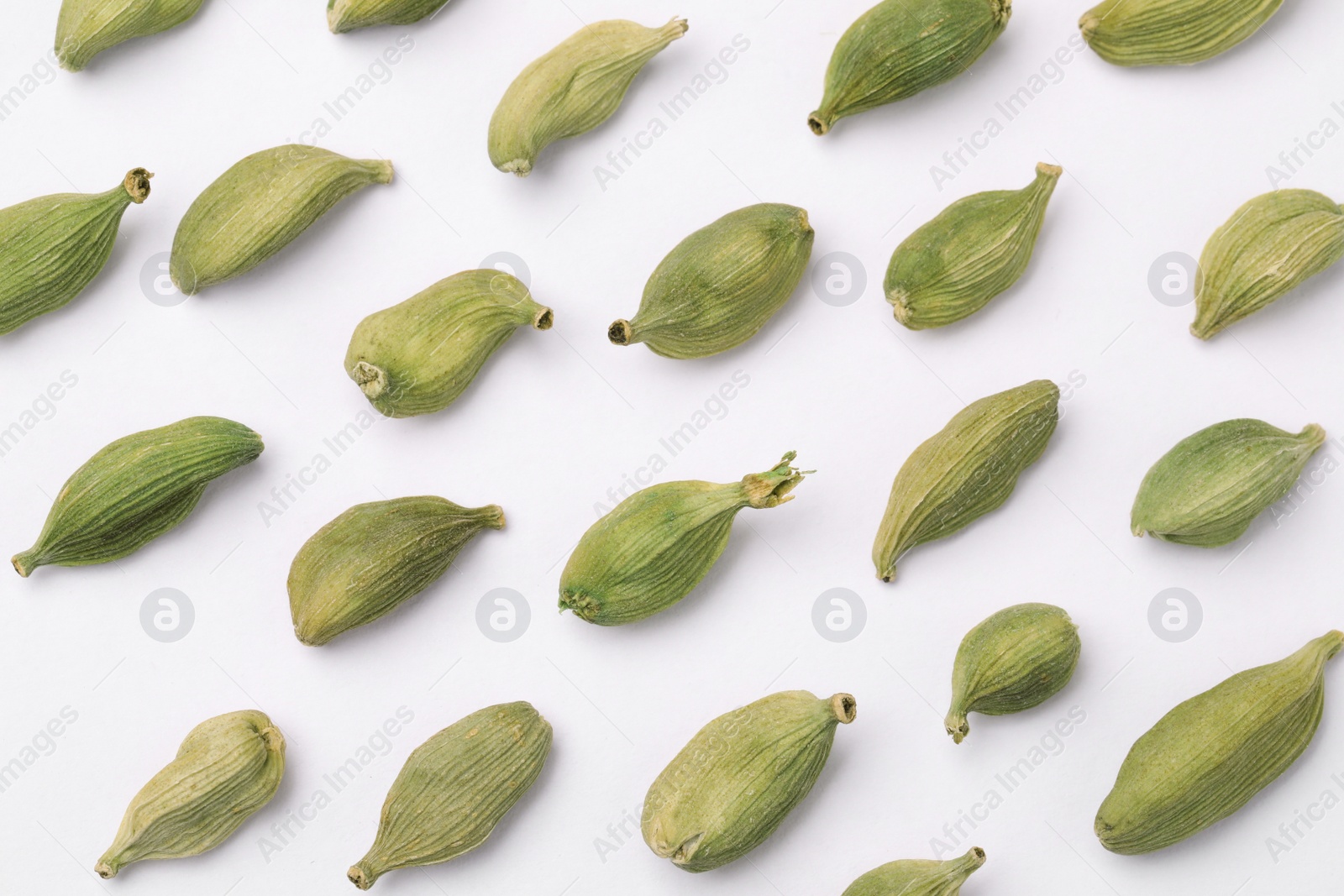 Photo of Many dry cardamom pods on white background, flat lay