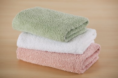 Photo of Stack of soft folded towels on wooden table