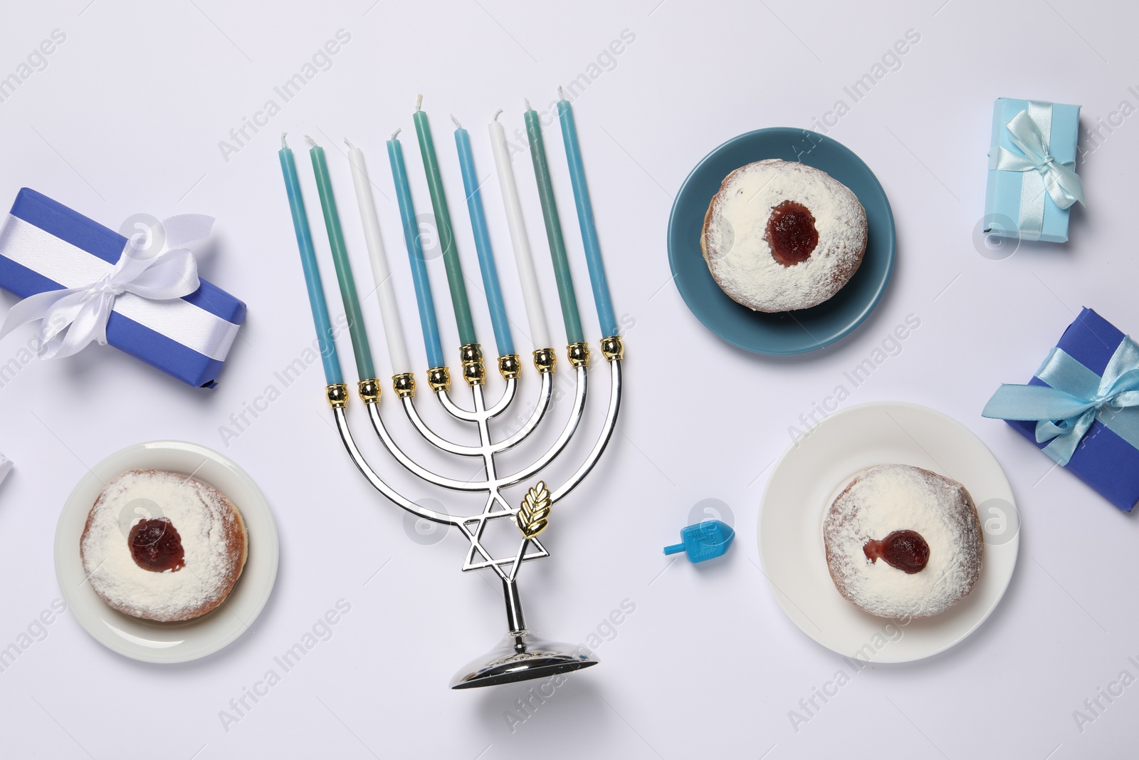 Photo of Flat lay composition with Hanukkah menorah and donuts on white background