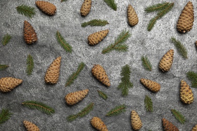 Flat lay composition with pinecones on grey background