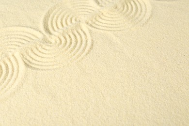 Zen rock garden. Wave pattern on beige sand