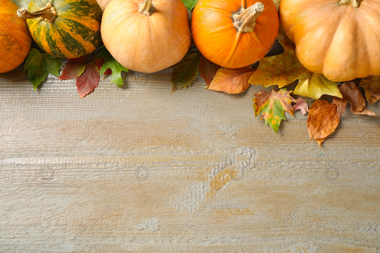 Photo of Autumn vegetables on wooden background, flat lay with space for text. Happy Thanksgiving day