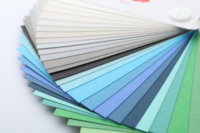 Photo of Color palette samples on white background, closeup