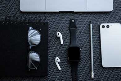 Photo of Flat lay composition with stylish smart watch on black table