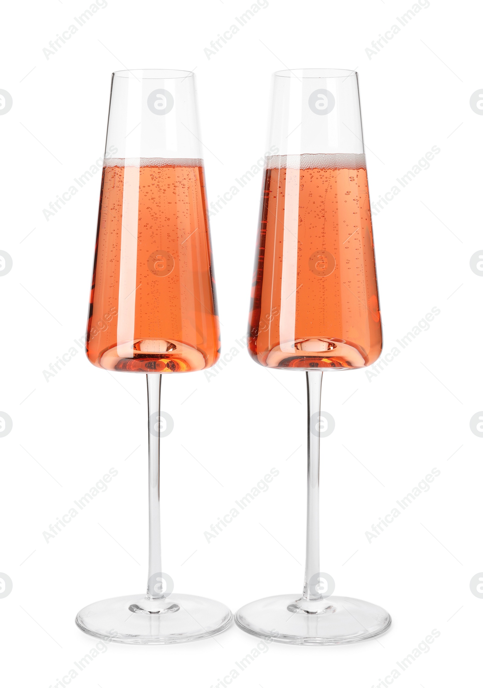 Photo of Glasses of rose champagne isolated on white