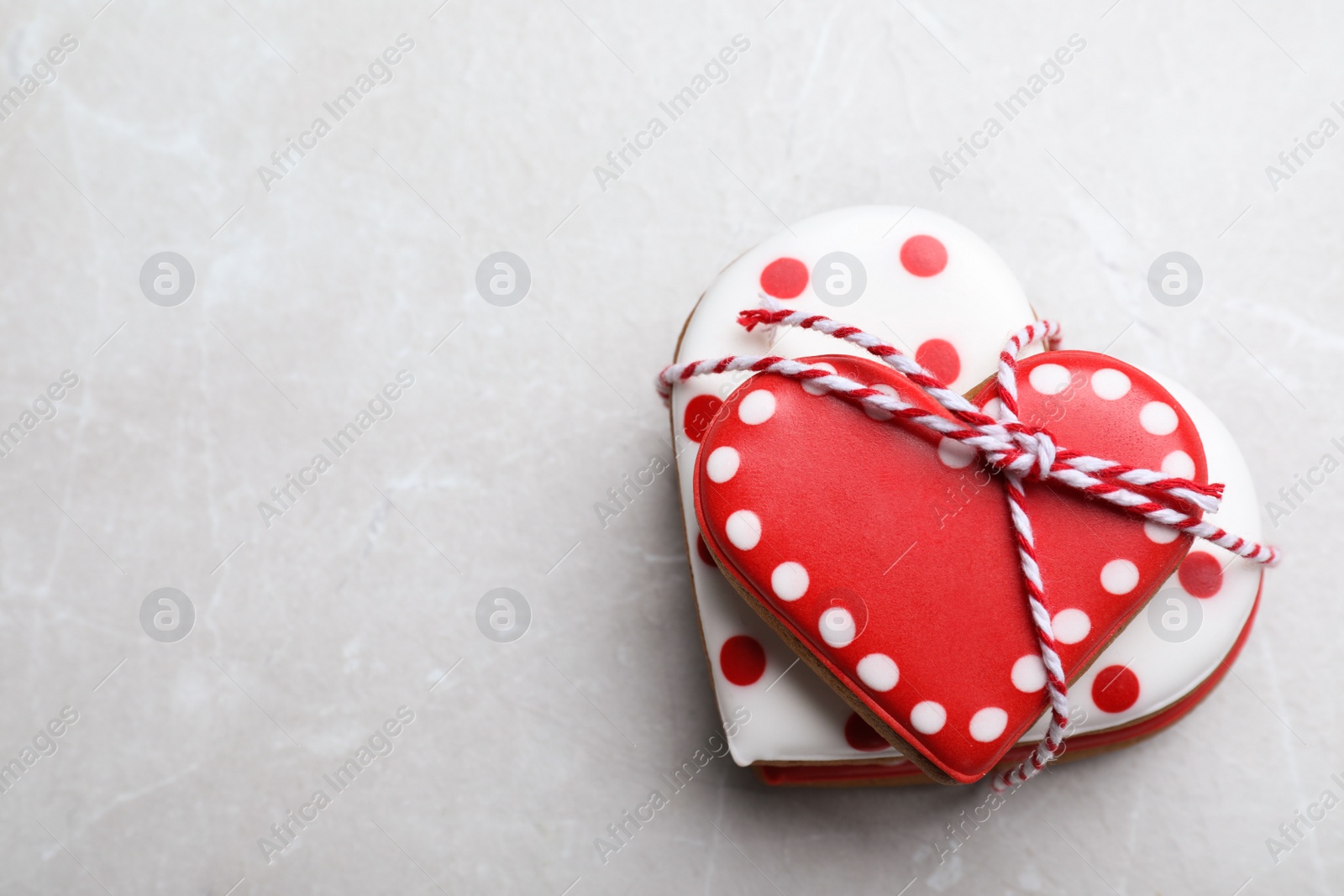 Photo of Delicious heart shaped cookies on light table, top view with space for text. Valentine's Day