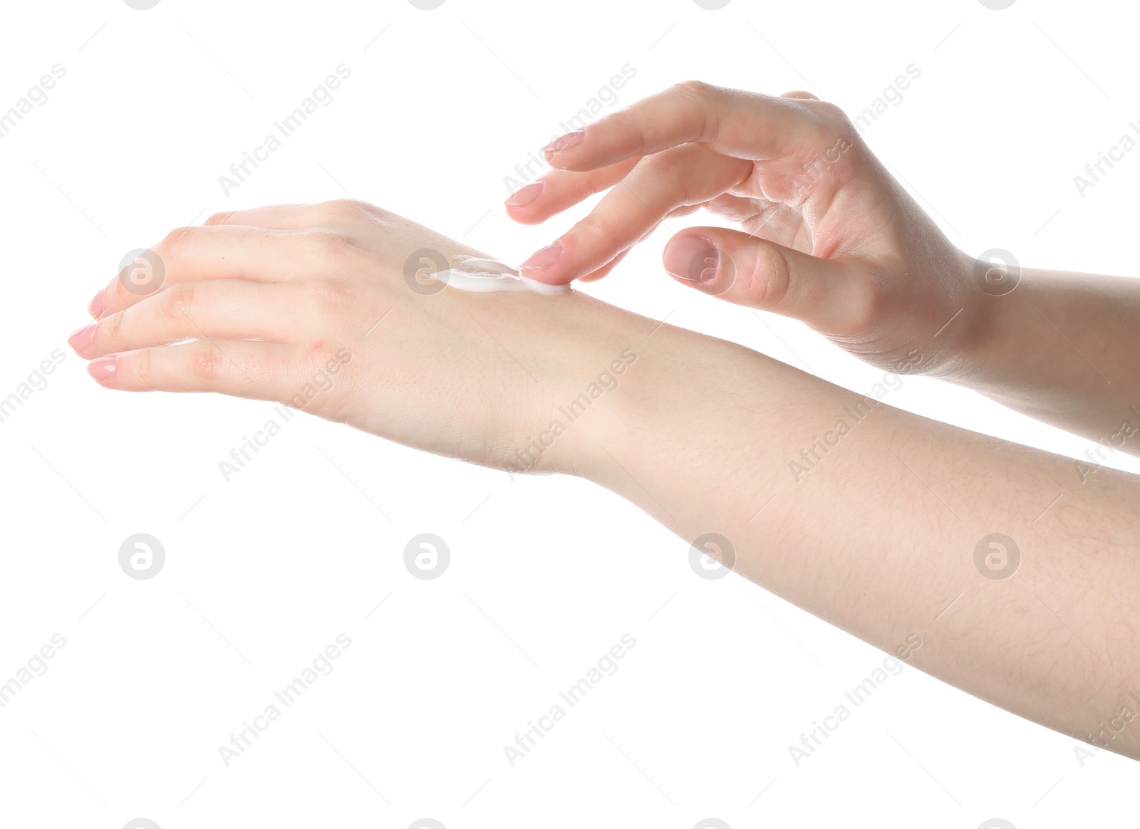 Photo of Woman applying cream on her hand against white background, closeup