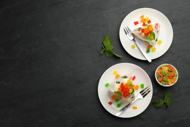 Delicious broken glass jelly dessert on black table, flat lay. Space for text