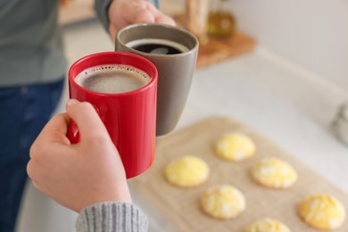 Couple drinking coffee at home, closeup. Space for text