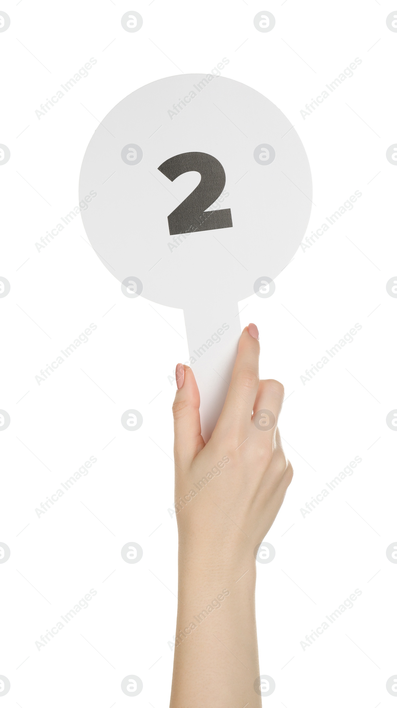 Photo of Woman holding auction paddle with number 2 on white background, closeup