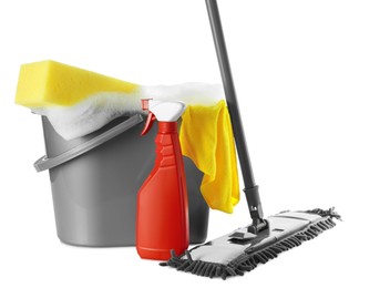 Photo of Plastic bucket with foam and cleaning supplies on white background