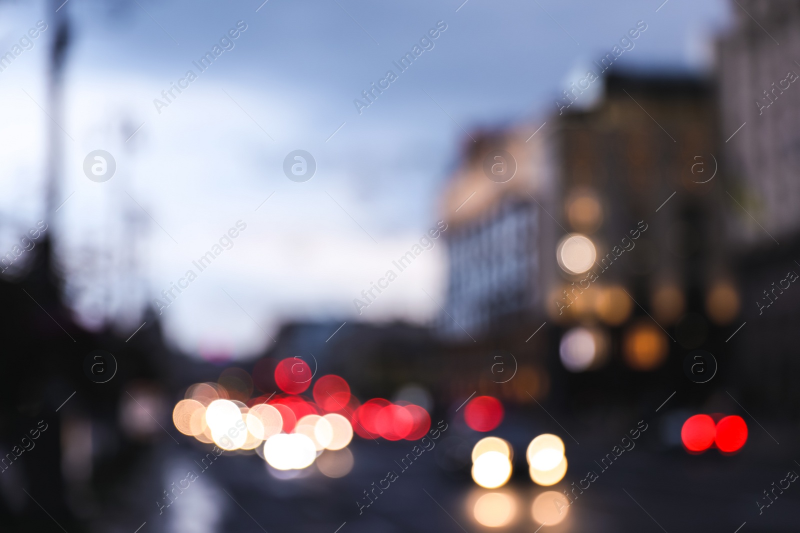 Photo of Blurred view of modern city at evening. Bokeh effect