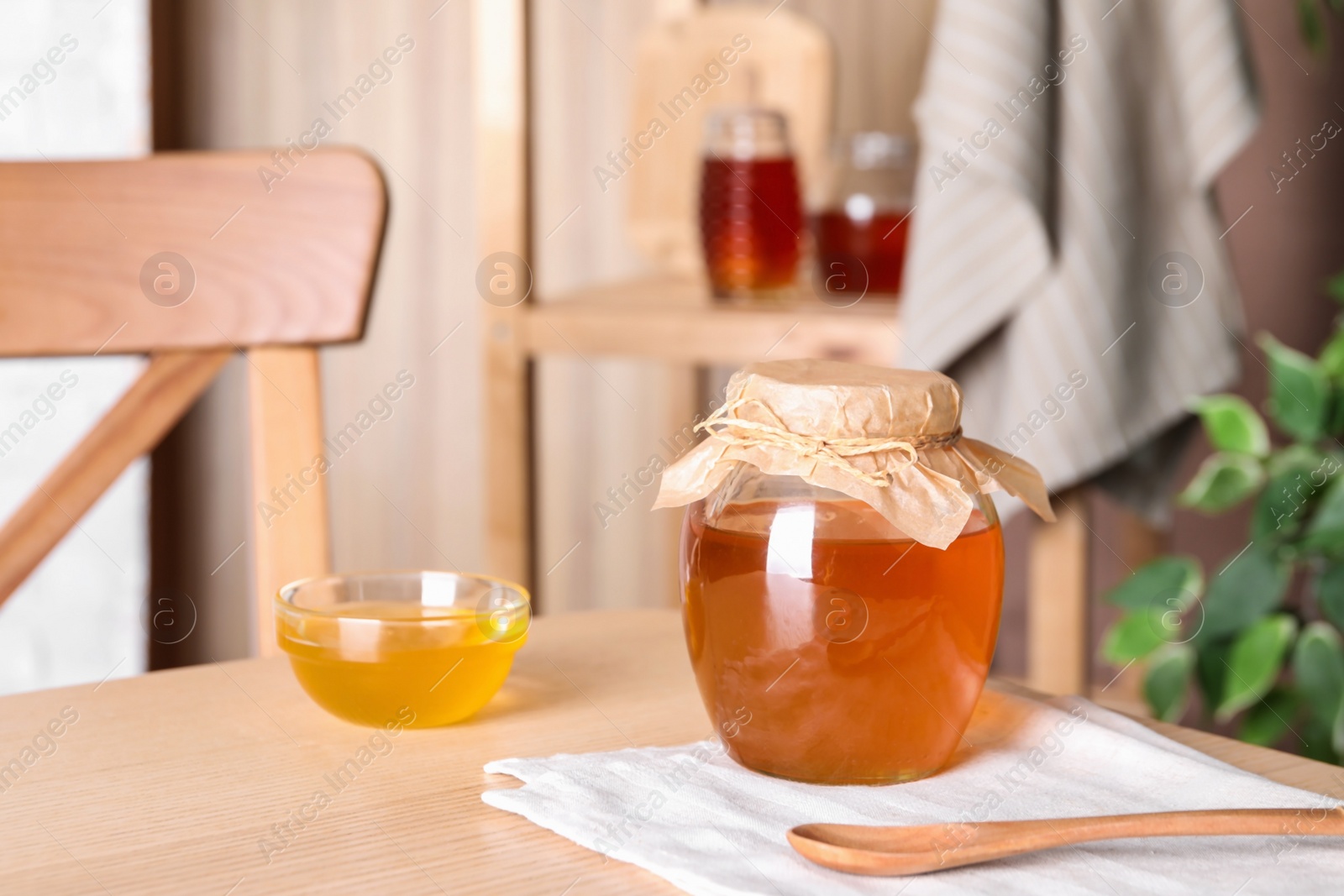 Photo of Tasty fresh organic honey on wooden table