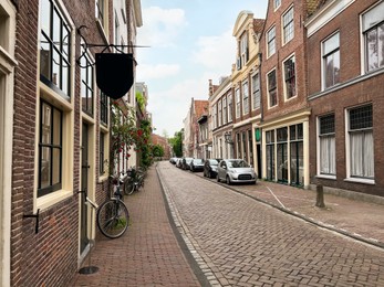 Beautiful view of city street with parked cars and bicycles