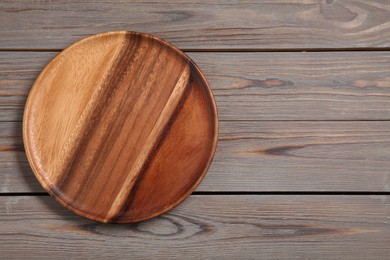 Photo of One plate on grey wooden table, top view. Space for text