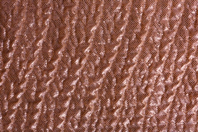 Photo of Rose gold fabric with shiny paillettes as background, top view