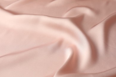 Photo of Crumpled pink silk fabric as background, closeup