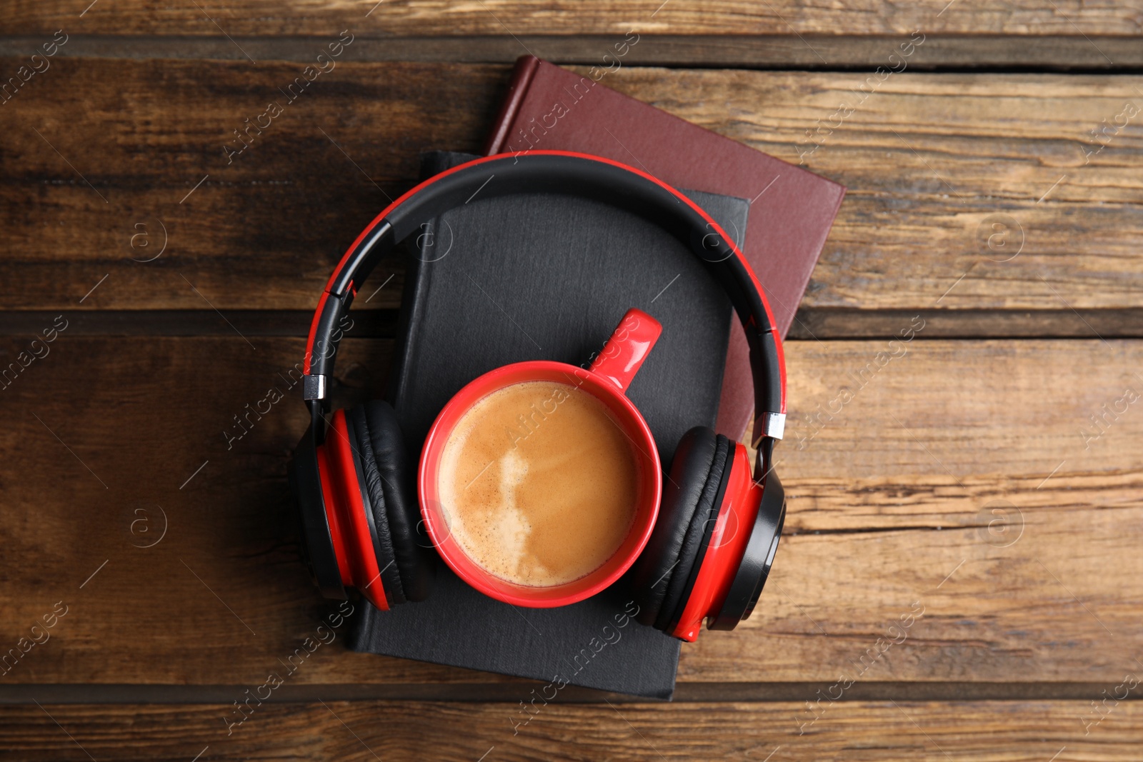 Photo of Books, coffee and headphones on wooden table, top view