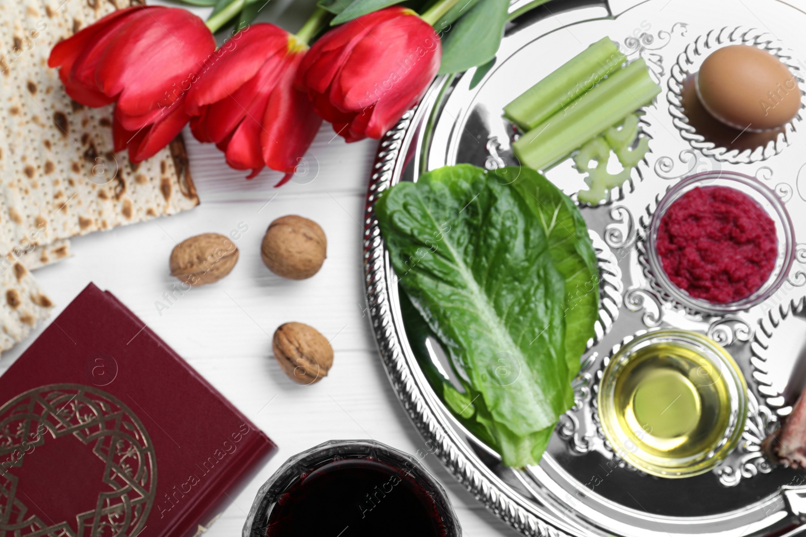 Photo of Flat lay composition with Passover Seder plate (keara) on white wooden table. Pesah celebration