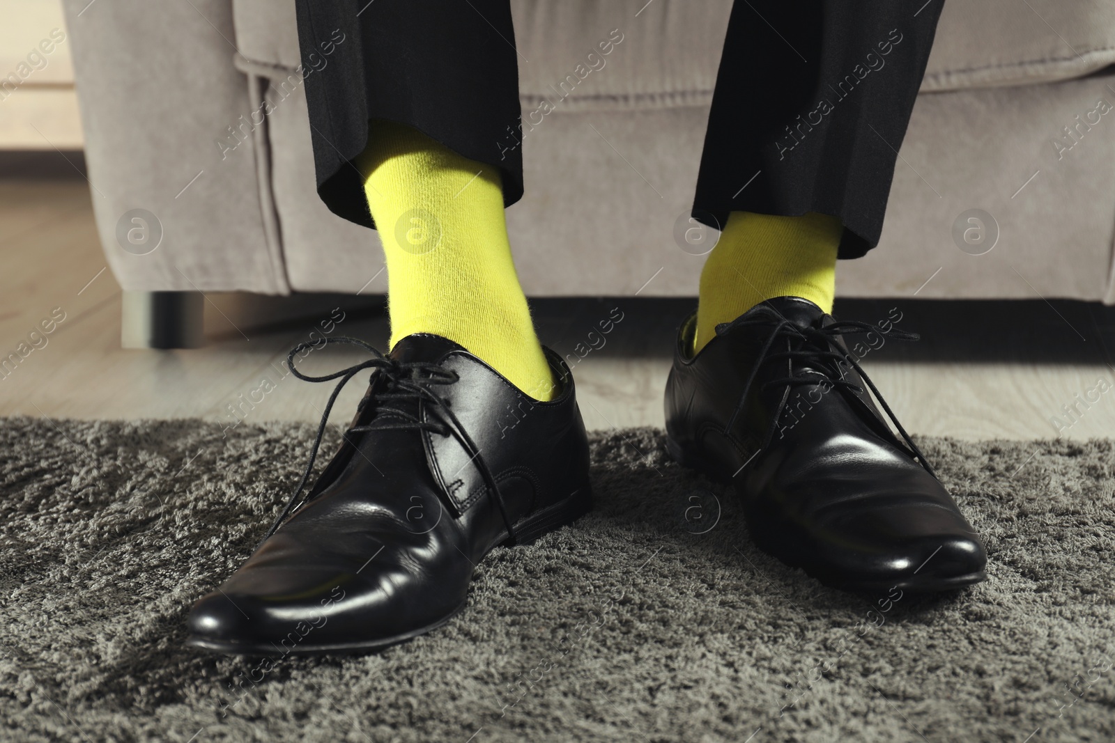 Photo of Man wearing stylish shoes and yellow socks indoors, closeup