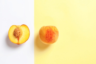 Flat lay composition with ripe peaches on color background