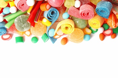 Photo of Many different yummy candies on white background, top view. Space for text