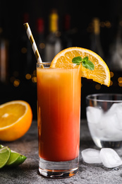 Fresh alcoholic Tequila Sunrise cocktail on grey table