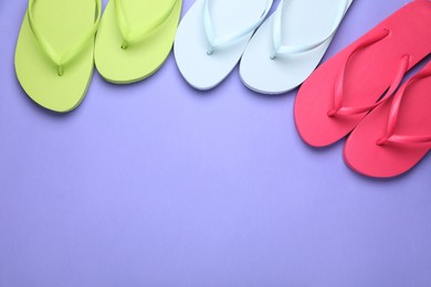Photo of Many different flip flops on light purple background, flat lay. Space for text