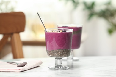 Photo of Glasses with tasty acai smoothie on table