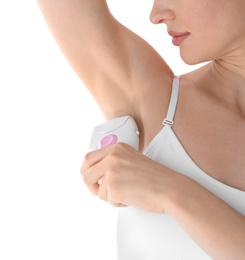 Young woman doing armpit epilation procedure on white background, closeup