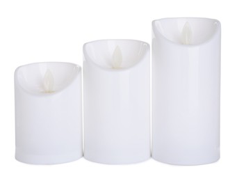 Photo of Decorative flameless LED candles on white background