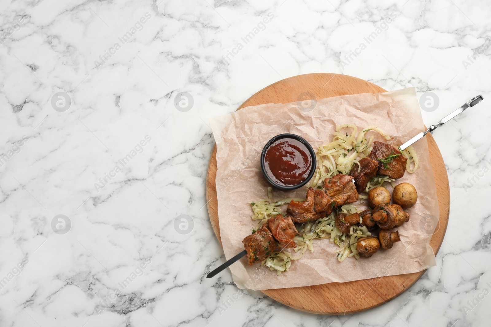 Photo of Metal skewer with delicious meat, vegetables and ketchup served on white marble table, top view. space for text