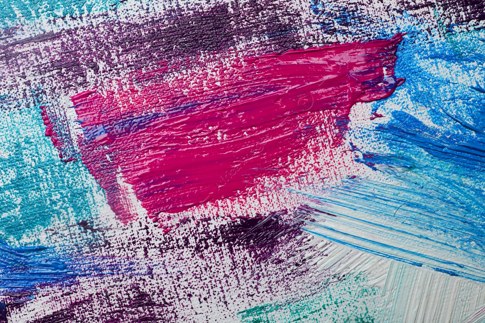 Photo of Strokes of colorful acrylic paints on white canvas, closeup