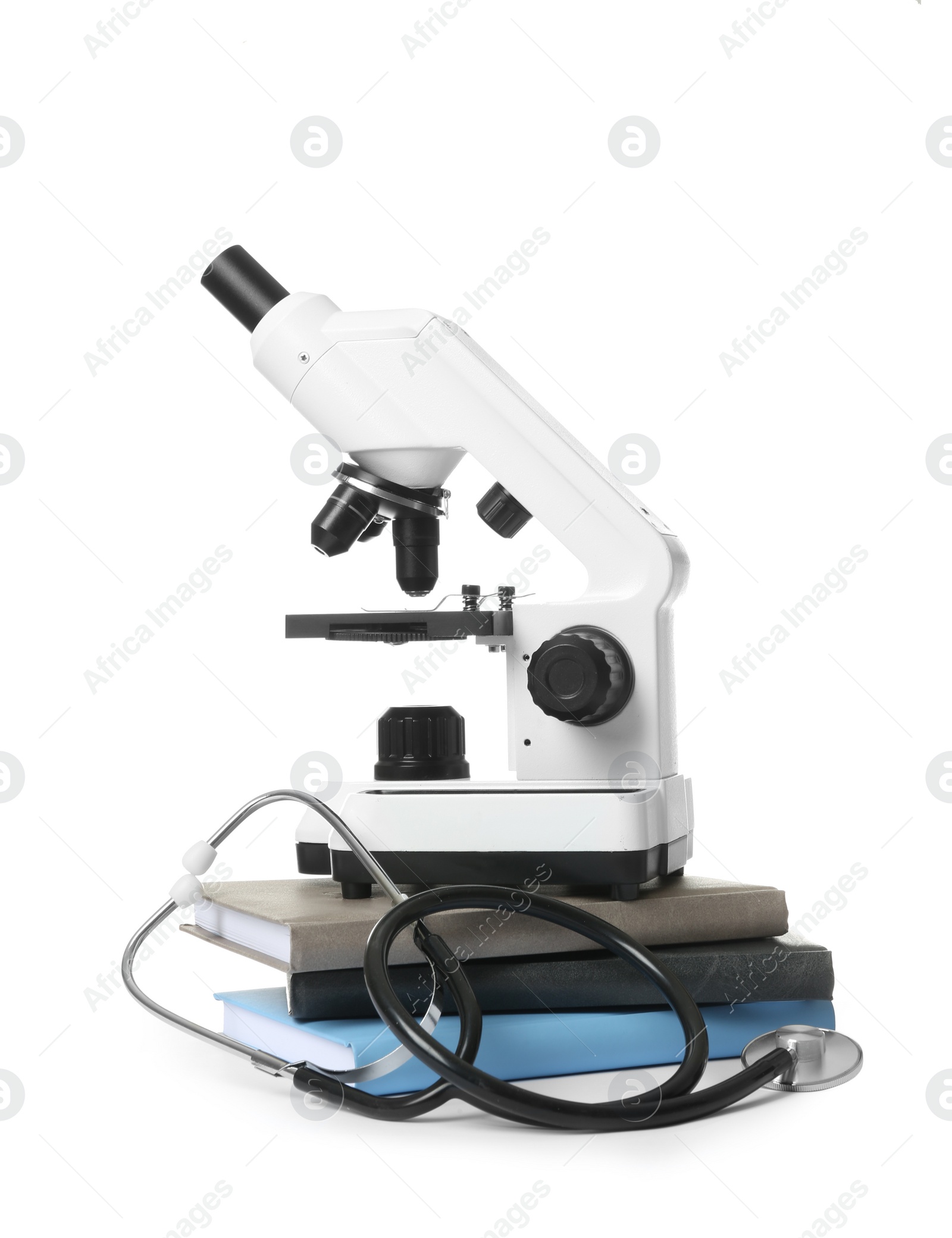 Photo of Microscope, stethoscope and books isolated on white. Medical students stuff