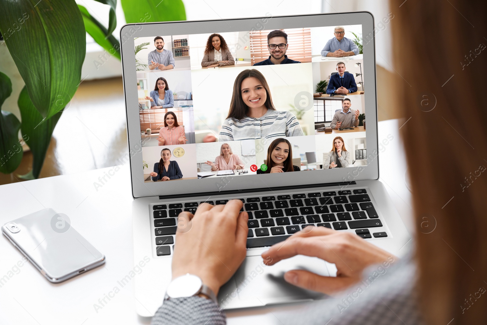 Image of Woman having video chat with team at table, closeup