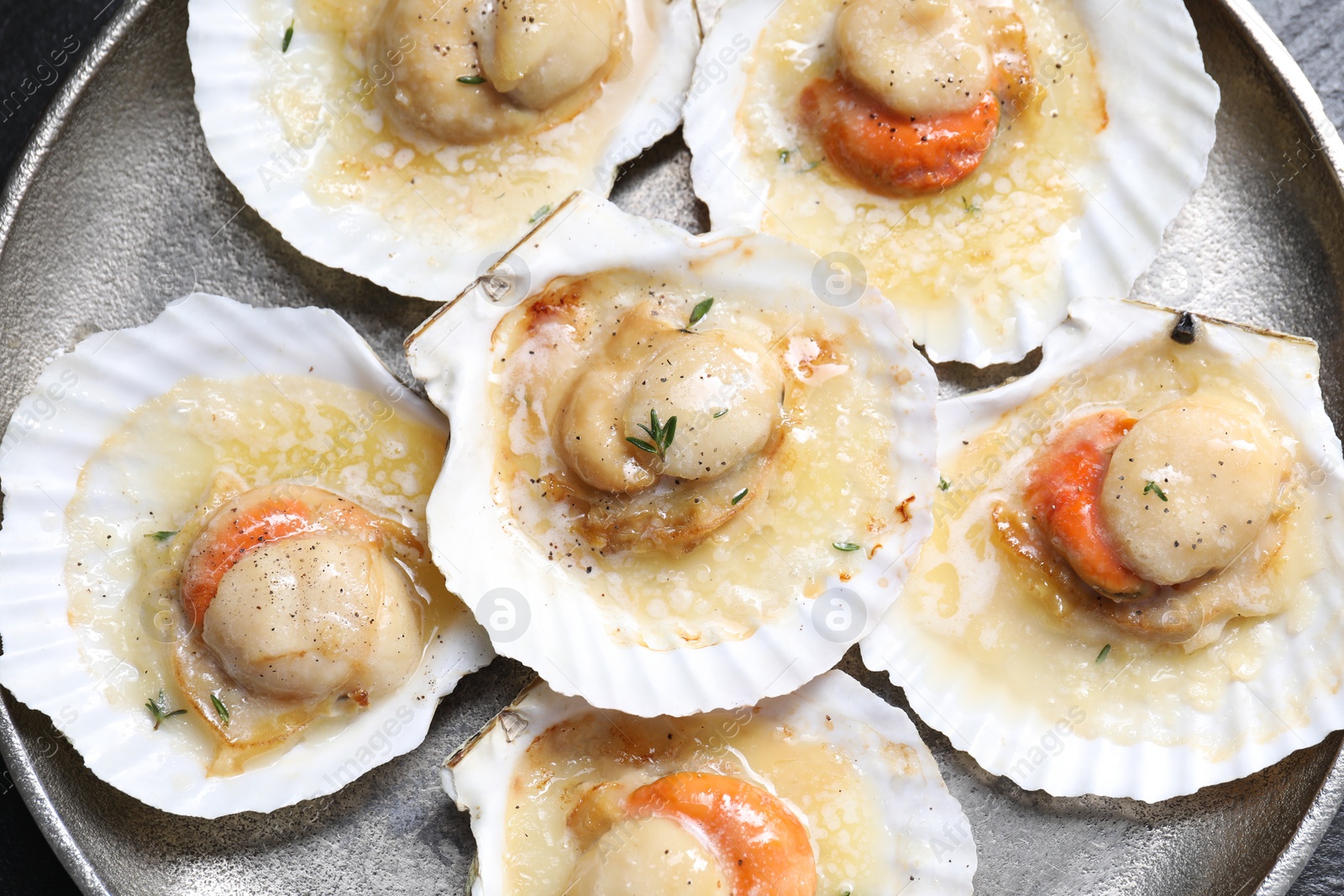 Photo of Fried scallops in shells on table, top view