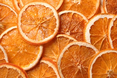 Photo of Heap of dry orange slices as background, top view