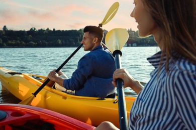 Beautiful couple kayaking on river. Summer activity