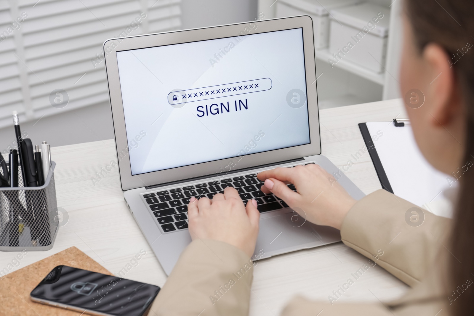 Photo of Woman unlocking laptop with blocked screen indoors, closeup