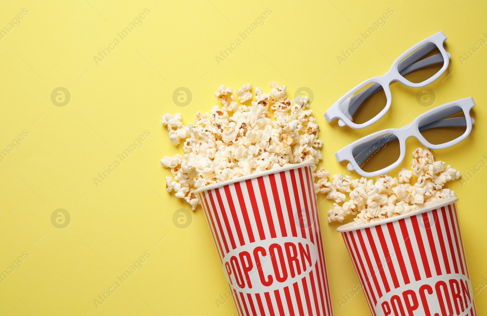 Photo of Flat lay composition with delicious popcorn on yellow background. Space for text