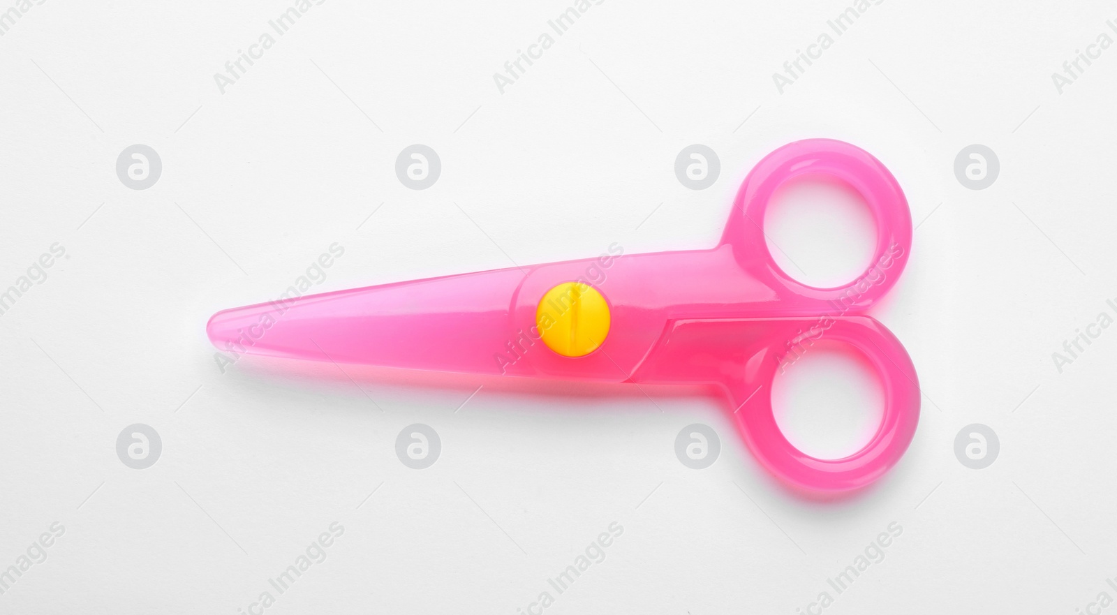 Photo of Colorful plastic scissors on white background. School stationery