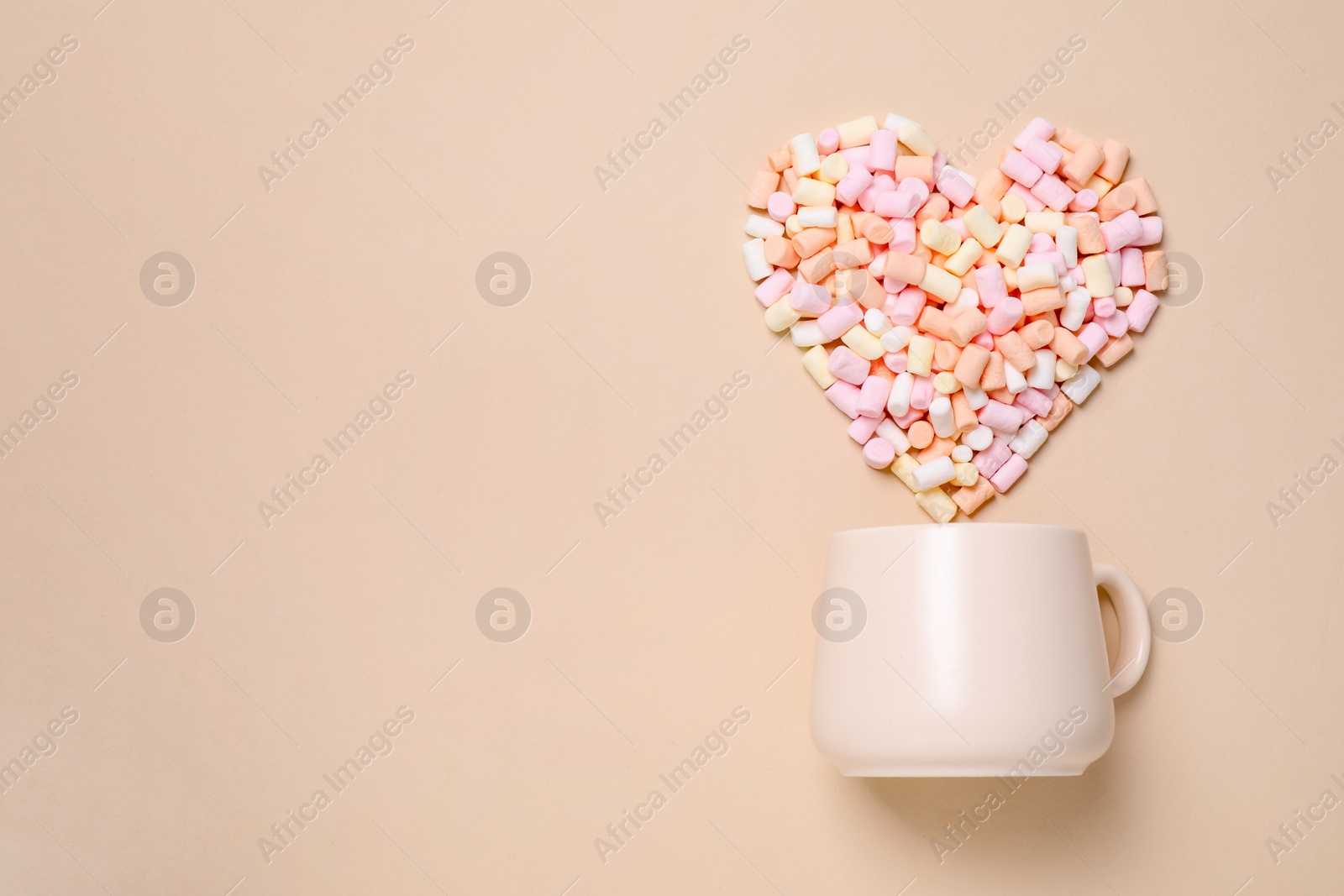 Photo of Cup and heart made of marshmallow on beige background, flat lay. Space for text