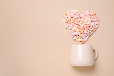 Photo of Cup and heart made of marshmallow on beige background, flat lay. Space for text