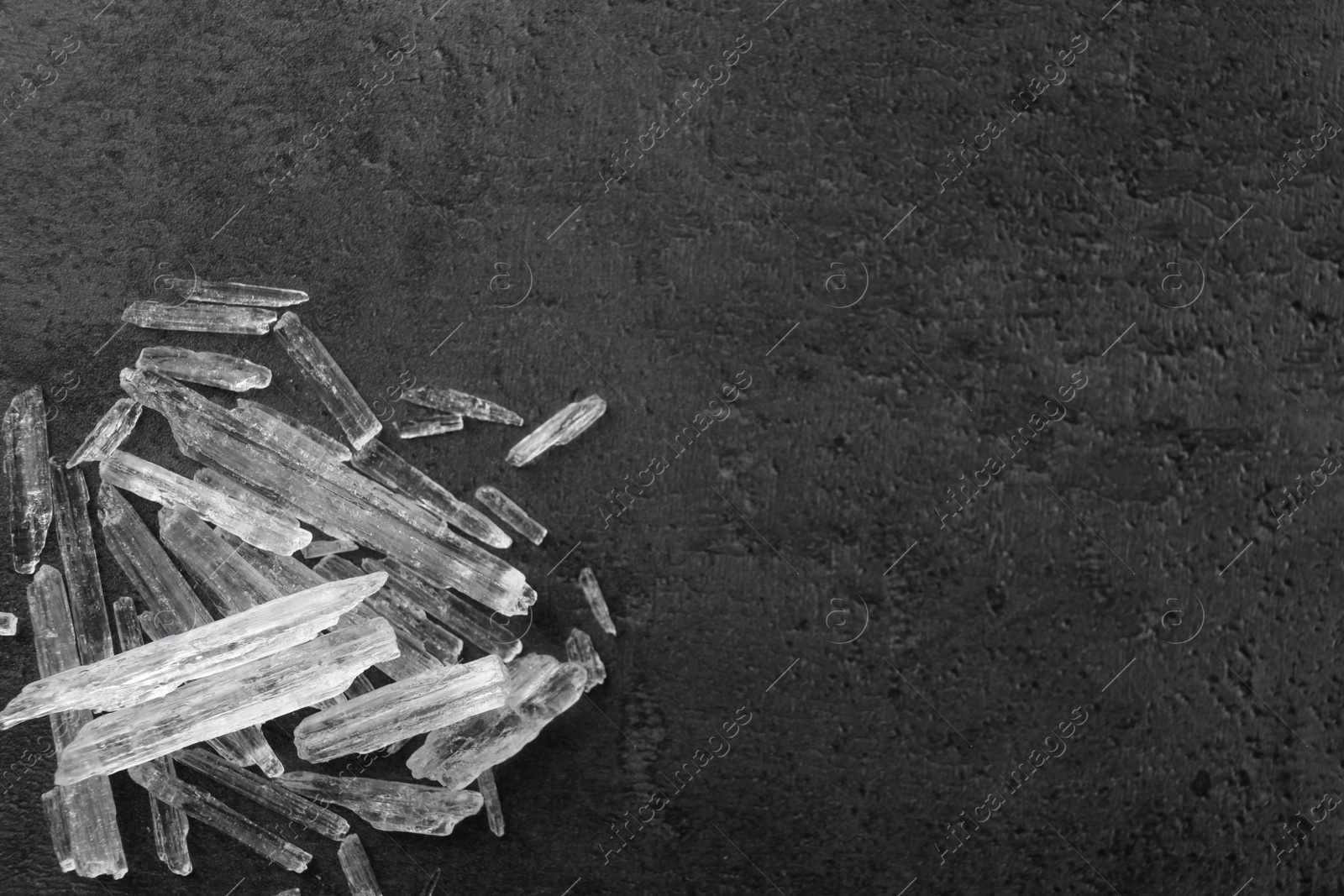 Photo of Menthol crystals on grey background, flat lay. Space for text