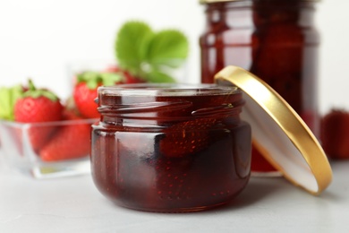 Delicious pickled strawberry jam and fresh berries on light table