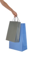 Photo of Woman with paper shopping bags on white background, closeup