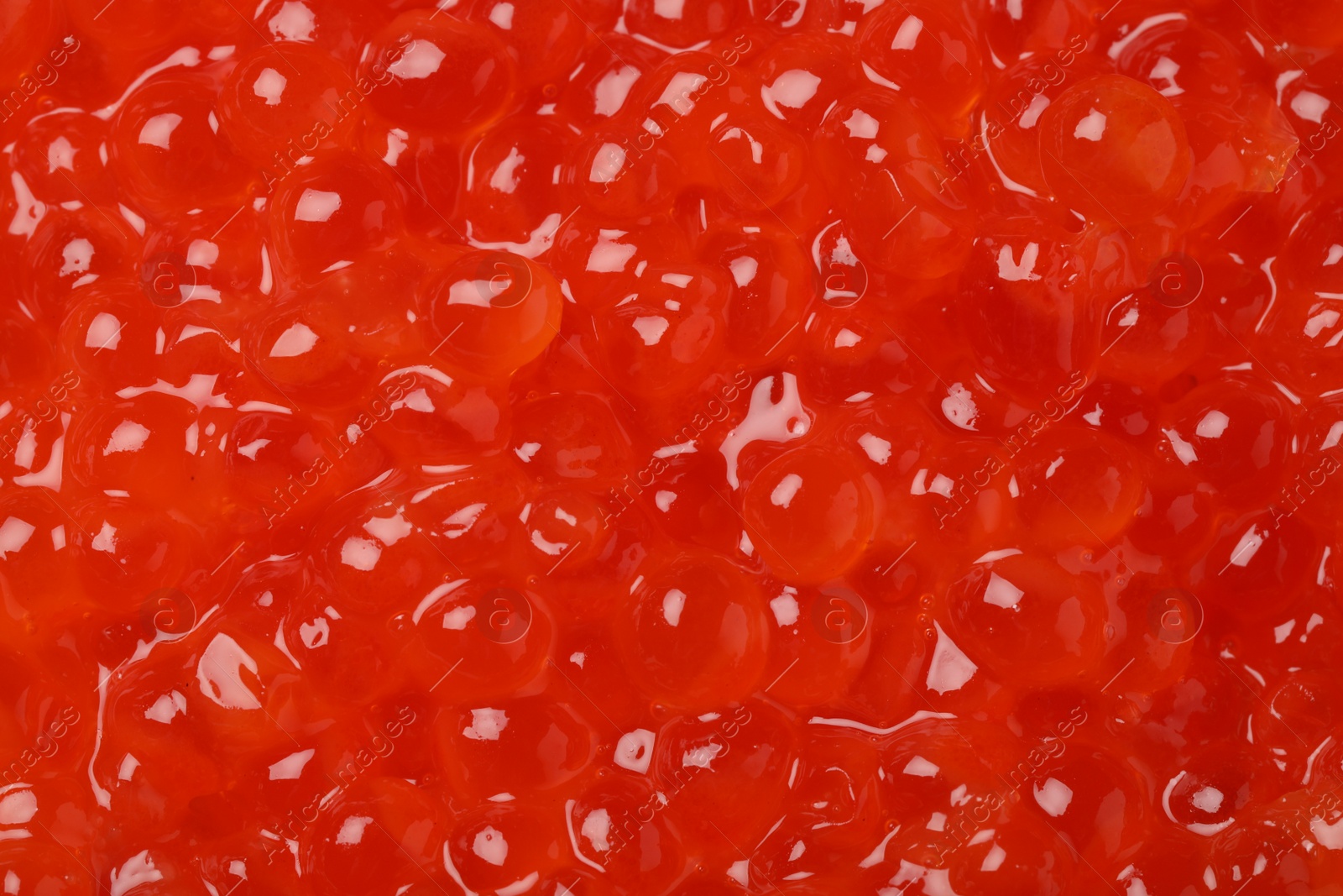 Photo of Delicious red caviar as background, top view